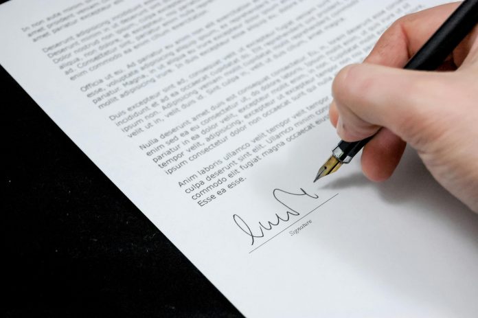 Hand signing a formal document